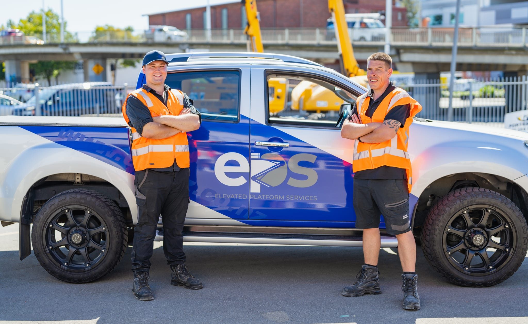 Elevated Platform Services team in front of their car at the Christchurch, New Zealand workshop
